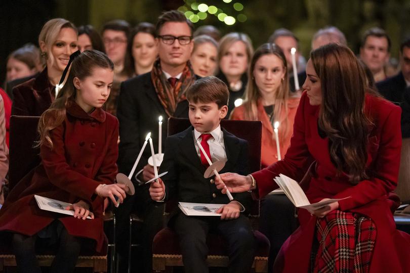 Princess Charlotte, from left, Prince Louis and Britain's Kate, the Princess of Wales, during the Together At Christmas carol service at Westminster Abbey.