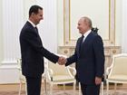 FILE PHOTO: Russian President Vladimir Putin (R) shakes hands with Syrian President Bashar al-Assad (L) during their meeting in Moscow, Russia in 2021.