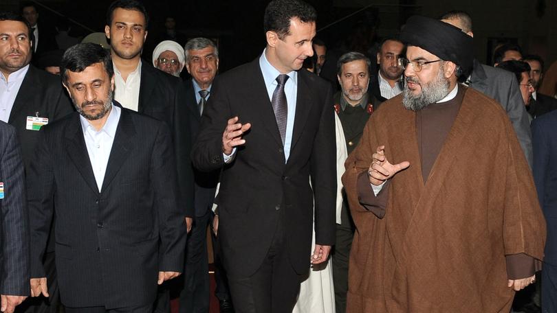 In Bashar al-Assad’s (C) fall, Tehran hasn’t only lost a client; it has seen its ability to project power, key to its own security, upended. (Former Iran President Mahmoud Ahmadinejad R)