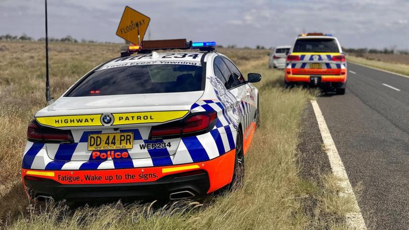 A pllice officer was found laying on the road next to his car.