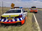 A pllice officer was found laying on the road next to his car.