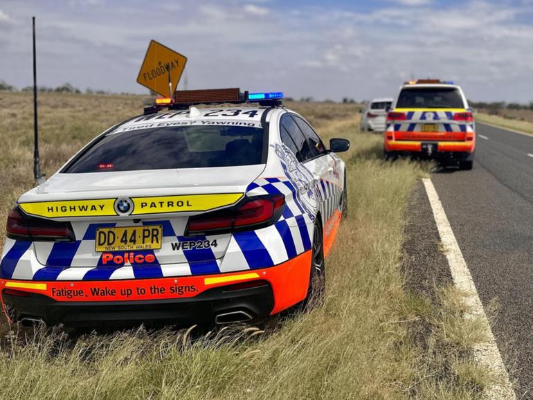 A pllice officer was found laying on the road next to his car.