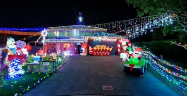 The two adjacent properties at the end of Troon Court, Glenmore Park, dazzle with their colourful lights displays and inflatables.