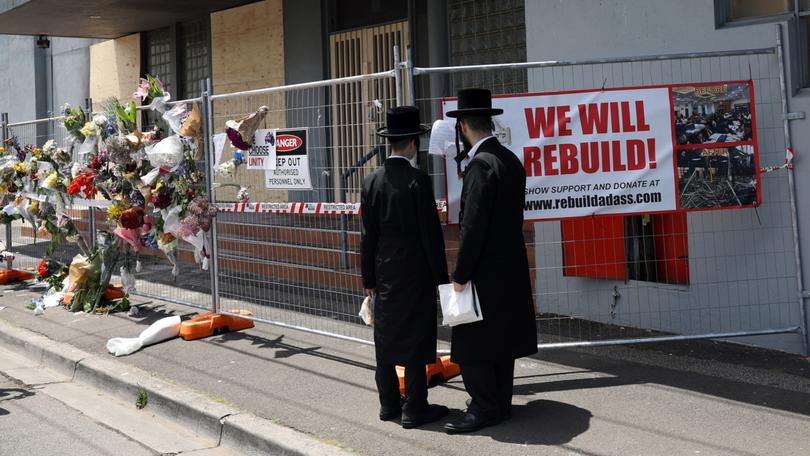 People gather outside the Adass Israel Synagogue after a firebombing in Melbourne, Monday, December 9, 2024. 