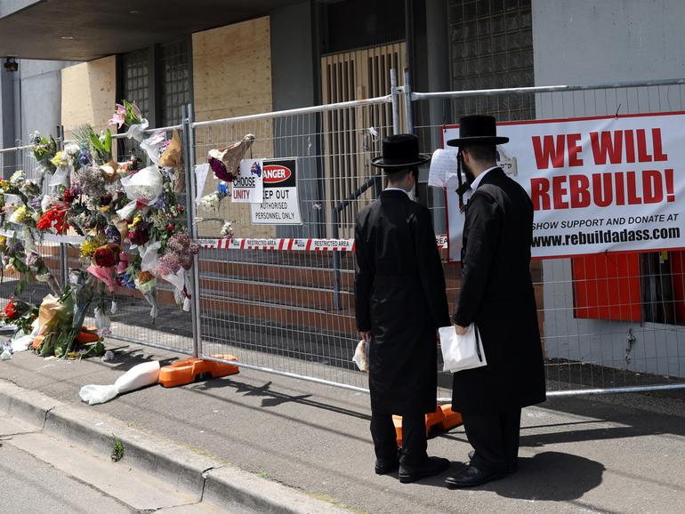 People gather outside the Adass Israel Synagogue after a firebombing in Melbourne, Monday, December 9, 2024. 