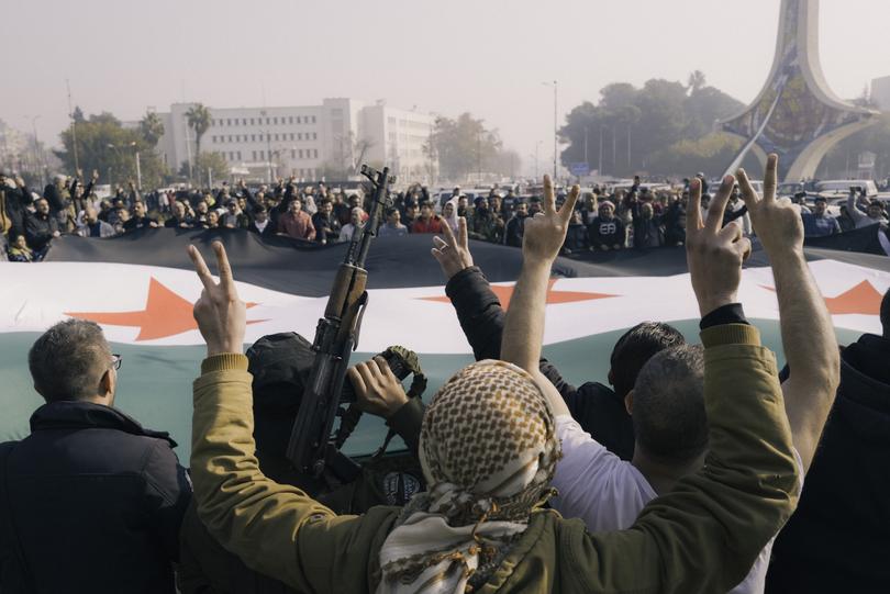 Syrians celebrate the fall of the Assad regime in central Damascus.