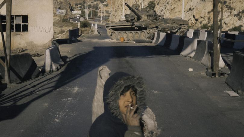 A destroyed army checkpoint and abandoned tank.