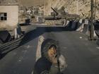 A destroyed army checkpoint and abandoned tank.