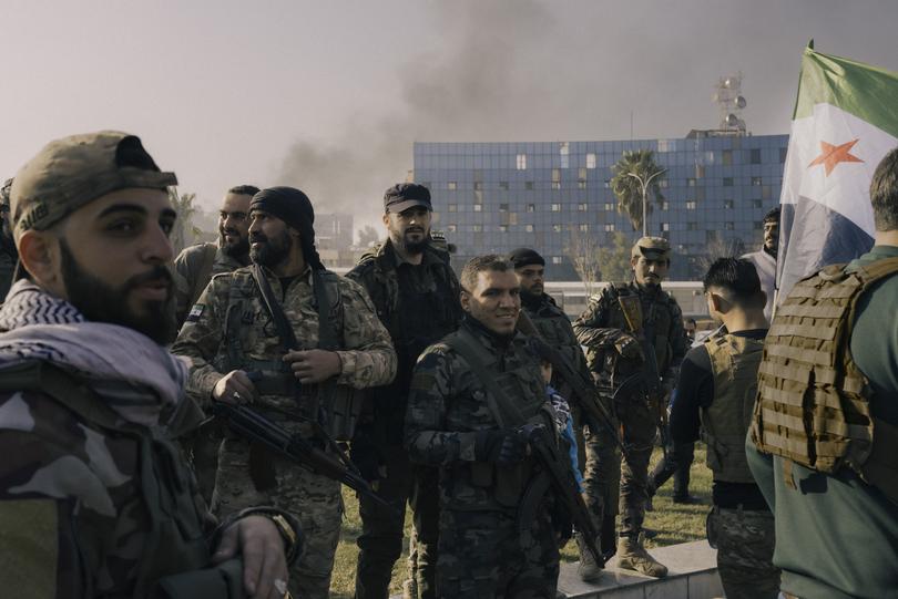 Militants celebrate the regime's fall in Damascus. (MUST CREDIT: Lorenzo Tugnoli for The Washington Post) 