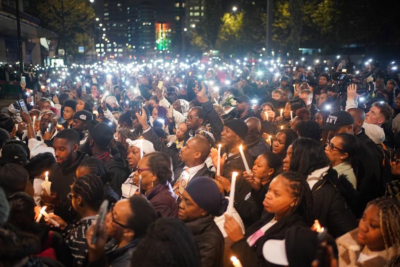 People attend a vigil outside the Whitgift shopping centre in Croydon, south London, for Elianne Andam, who was stabbed on her way to school.