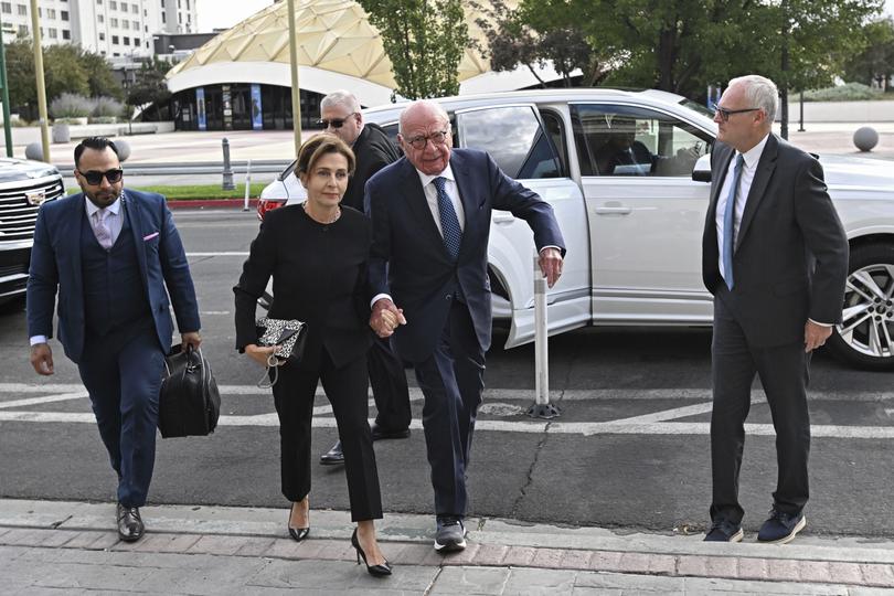 Rupert Murdoch, center, and his wife Elena Zhukova Murdoch arrive at the Second Judicial District Court in Reno, Nev., Monday Sept. 16, 2024. (AP Photo/Andy Barron)