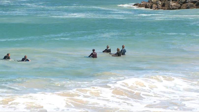 The attack at Pyramids Beach did not stop others from entering the water.