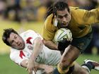 Tom Voyce (left) attempts to tackle George Smith (right) while playing for England in Sydney in 2006. (AP PHOTO)