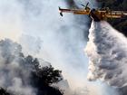 A firefighting aircraft drops water as the Franklin Fire continues to burn near Malibu, California.