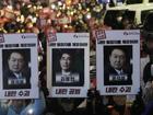 Protesters carried "Arrest the rebellion criminals" signs during South Korea's martial law.