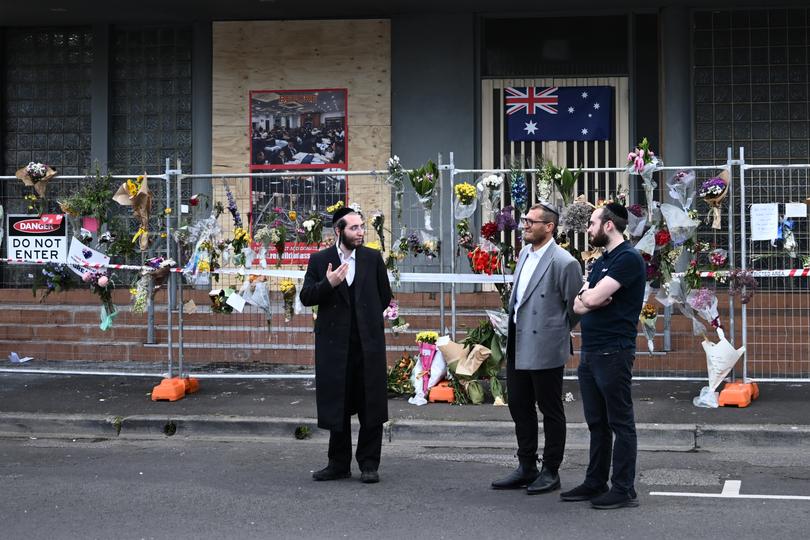 Rabbi Gabi Kaltmann (centre) at the Adass Israel Synagogue after a firebombing in Melbourne, Tuesday, December 10, 2024. 