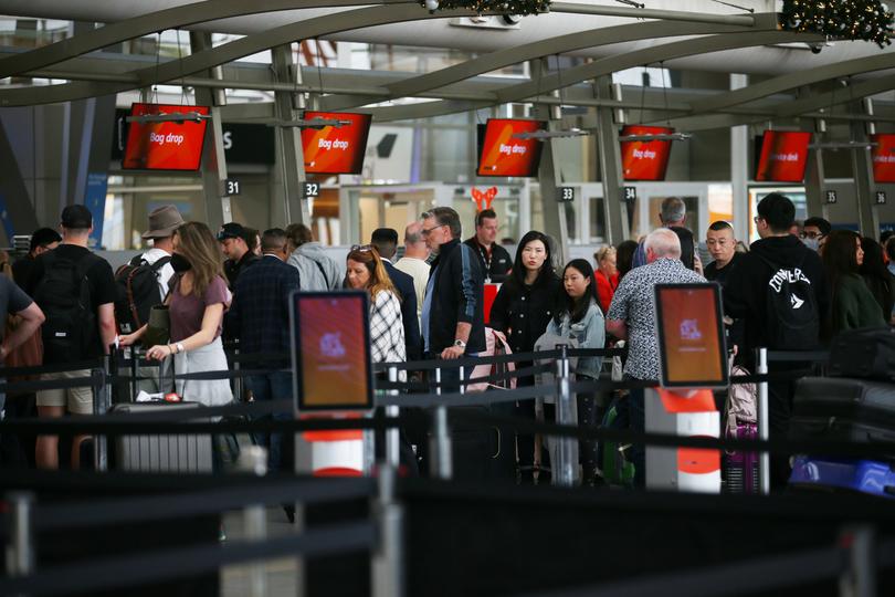 Travellers arrive and depart at Sydney Domestic Airport.