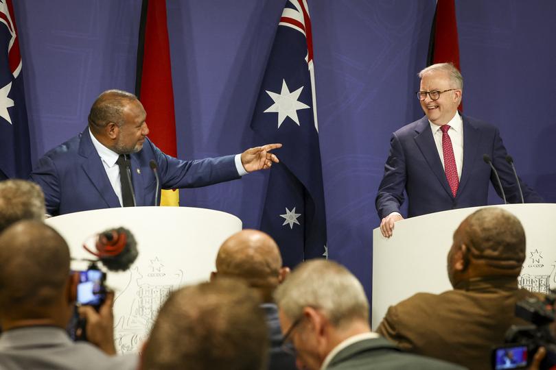 Australian Prime Minister Anthony Albanese (R) reacts as Papua New Guinea's Prime Minister James Marape speaks during a press conference in Sydney on December 12, 2024. 