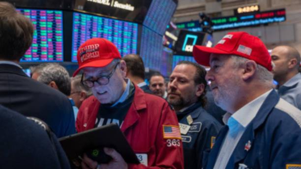 Traders watch as President-elect Donald Trump walks onto the floor of the New York Stock Exchange.