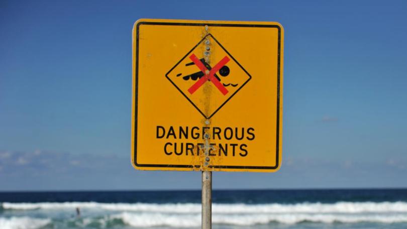 Warning signs were on a beach where four people were caught in a rip and drowned. 