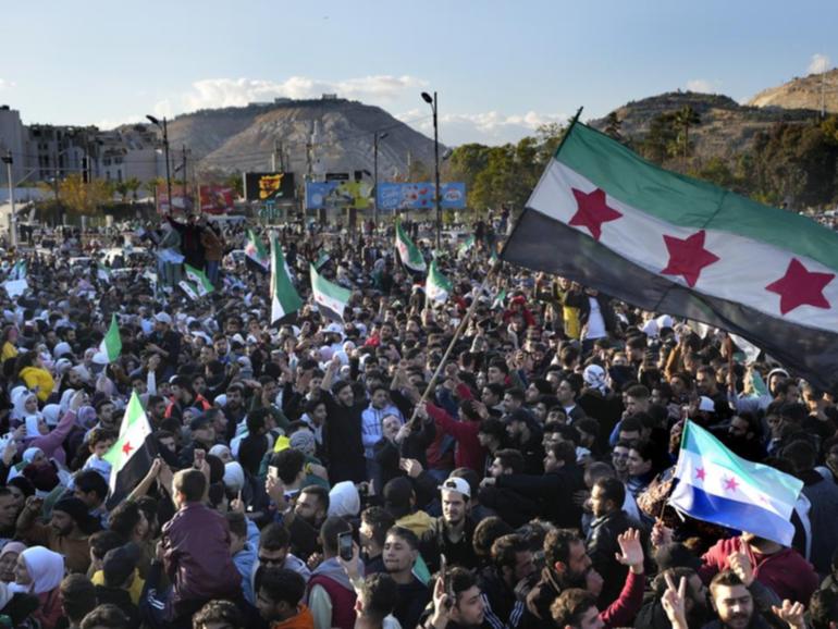 Thousands have assembled in Damascus after prayers to celebrate the end of Bashar al-Assad's rule. (AP PHOTO)