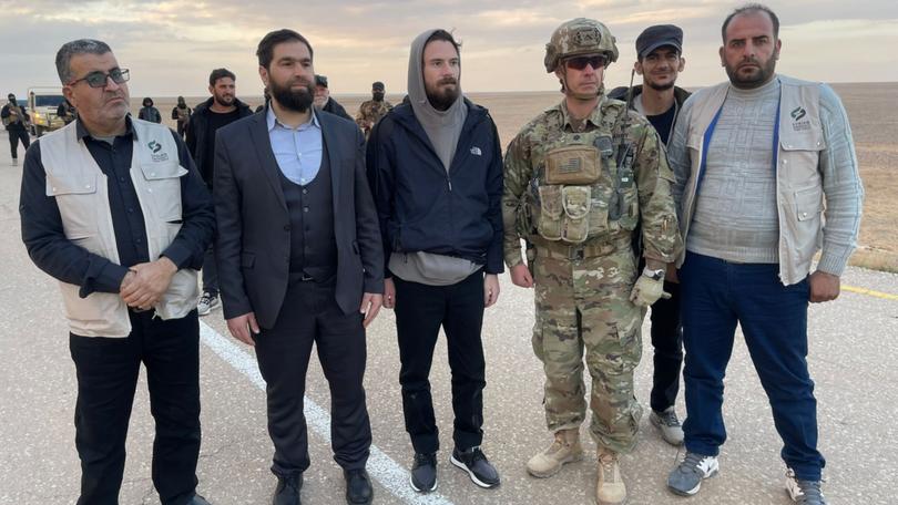 Syrian rebels escorted American Travis Timmerman, centre, to a U.S. military outpost near Jordan's border on Friday. 