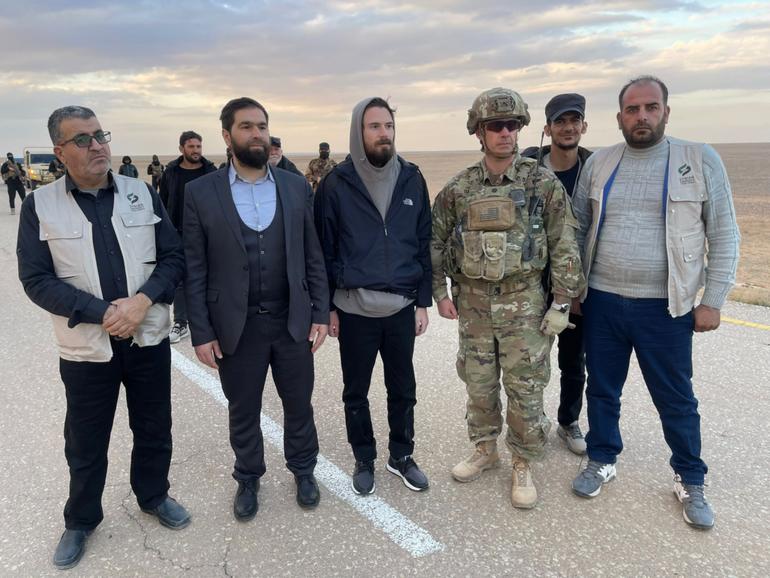 Syrian rebels escorted American Travis Timmerman, centre, to a U.S. military outpost near Jordan's border on Friday. 