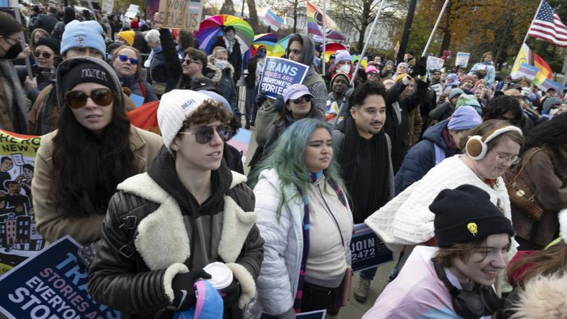 Hundreds of transgender men and women, activists and supporters rally outside the U.S. Supreme Court on Dec. 4 after the justices heard arguments on a Tennessee law banning gender-affirming treatment for minors. MUST CREDIT: Marvin Joseph/The Washington Post