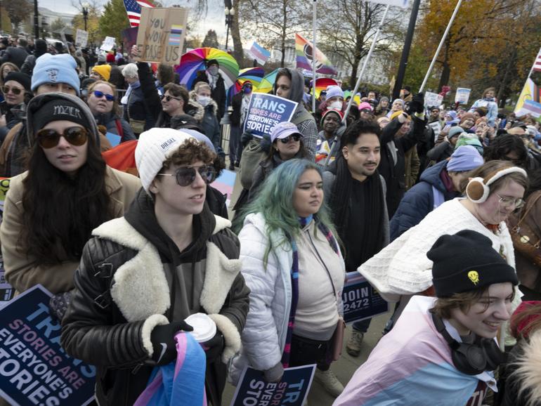 Hundreds of transgender men and women, activists and supporters rally outside the U.S. Supreme Court on Dec. 4 after the justices heard arguments on a Tennessee law banning gender-affirming treatment for minors. MUST CREDIT: Marvin Joseph/The Washington Post