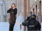 **FILE** A Dec. 15, 2014 file image of Sydney Siege hostage Elly Chen runs from the Lindt Chocolate cafe in Martin Place, Sydney. The long-running inquest into the deadly Lindt cafe siege has wrapped up its public hearings in Sydney, with NSW Police Commissioner Andrew Scipione the last witness to give evidence. (AAP Image/Joel Carrett) NO ARCHIVING