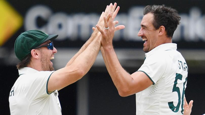 Mitch Marsh and Mitchell Starc celebrate the early wicket of Shubman Gill.