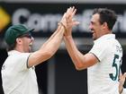 Mitch Marsh and Mitchell Starc celebrate the early wicket of Shubman Gill.