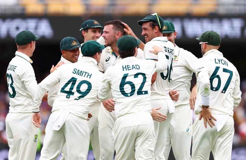 Josh Hazlewood of Australia celebrates with teammates after dismissing Virat Kohli.