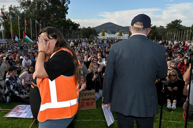 An organiser cries as Prime Minister Anthony Albanese addresses a rally calling for action to end violence against women, in front of Parliament House in Canberra, Sunday, April 28, 2024. 