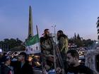 Rebel fighters celebrate with other Syrians after the fall of Bashar al-Assad’s regime, in Damascus, Dec. 9, 2024. 