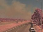 An out-of-control bushfire in Port Kennedy has been downgraded to a watch and act alert as firefighters battle the blaze with backburning operations.