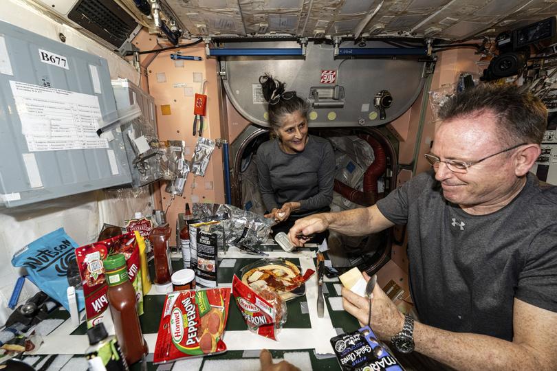 Suni Williams and Butch Wilmore make pizza aboard the International Space Station's galley.