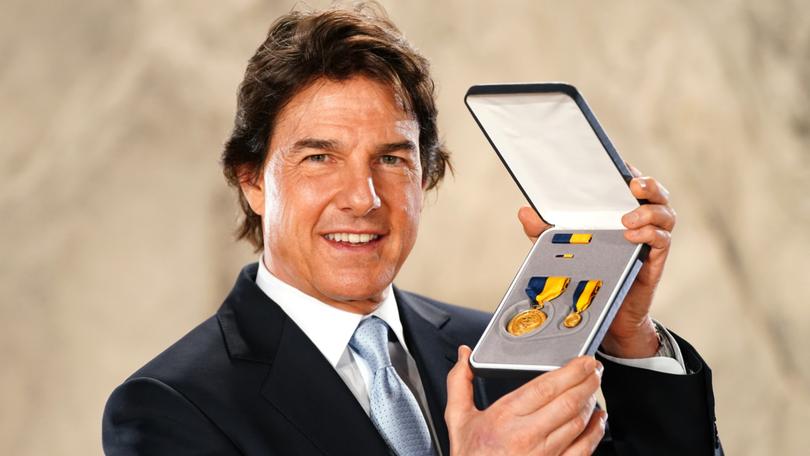 Actor Tom Cruise after being presented with the US Navy Distinguished Public Service Award by US Secretary of the Navy, Carlos Del Toro.