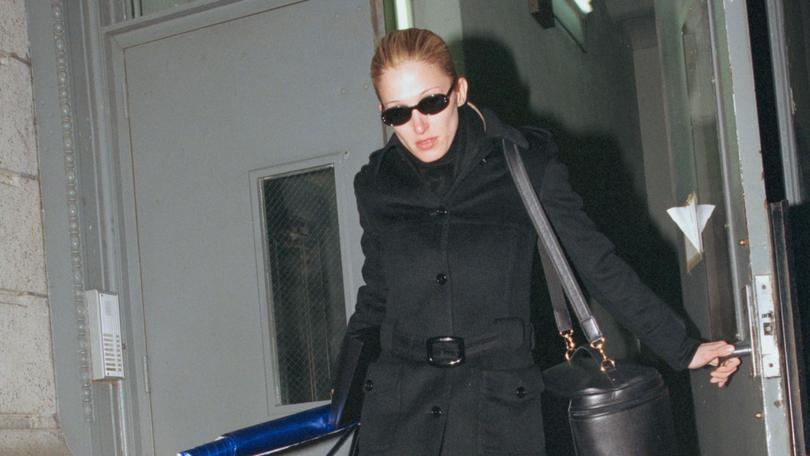 Carolyn Bessette in her black Prada coat in 1997 and, left, with husband John Kennedy Jr in New York.