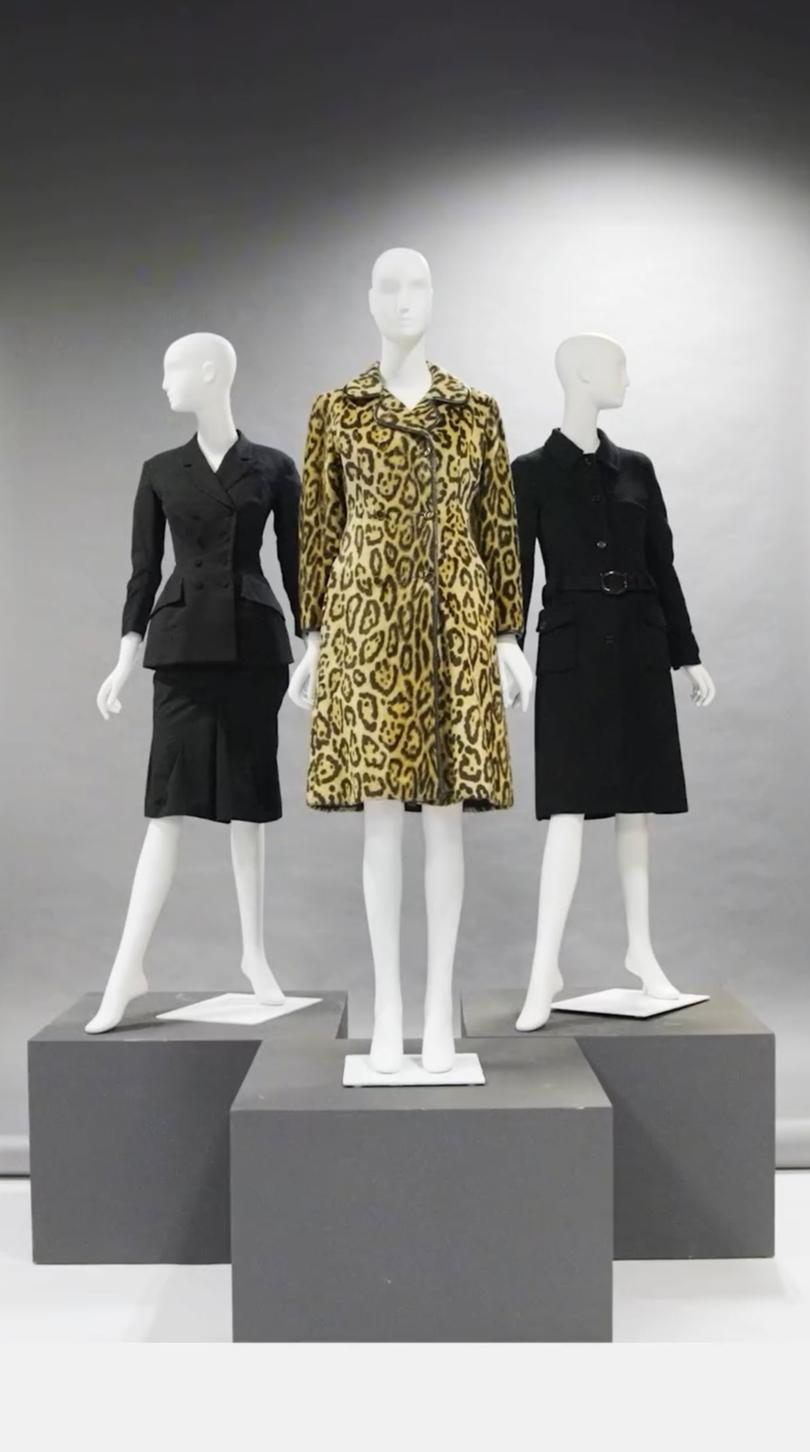 Carolyn Bessette-Kennedy coats displayed at Sothebys, including her Yohji Yamamoto black wool double-breasted jacket, 1997, vintage double-breasted faux-leopard fur coat, circa 1969 and her Prada single-breasted black double-faced wool coat, 1997.