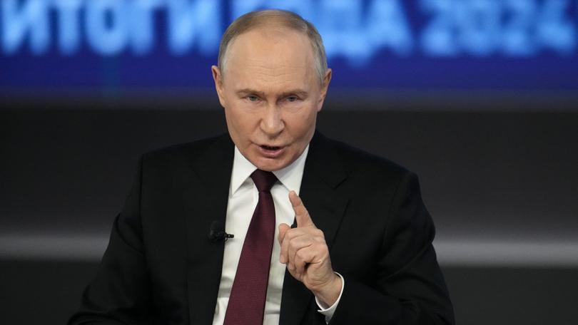 Russian President Vladimir Putin gestures as he speaks during his annual news conference.