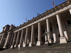 About 20 masked men allegedly posed with offensive signs outside Victorian parliament. 