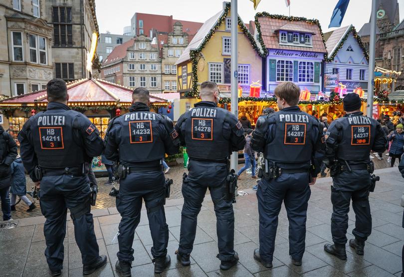 Police officers stand in front of the stalls at the Christmas market in Bremen, after the Magdeburg's Christmas market attack the day before.