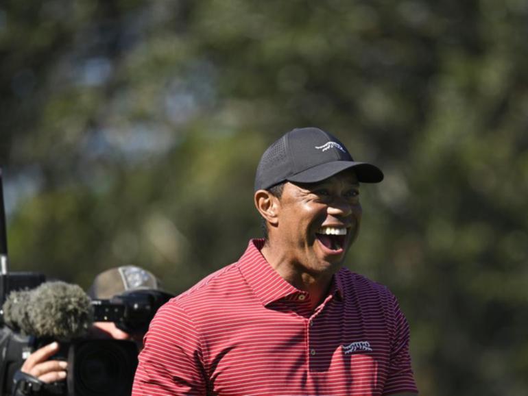 Tiger Woods couldn't believe it when son Charlie made a hole-in-one at the PNC Championship. (AP PHOTO)