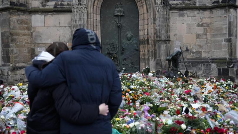 Germany remains in shock and mourning two days after the deadly attack on a Christmas market. (AP PHOTO)