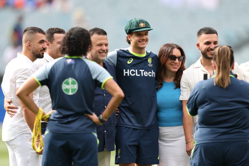 MELBOURNE, AUSTRALIA - DECEMBER 26: Sam Konstas of Australia poses for photographs after being presented with a Baggy Green during day one of the Men's Fourth Test Match in the series between Australia and India at Melbourne Cricket Ground on December 26, 2024 in Melbourne, Australia. (Photo by Robert Cianflone/Getty Images)