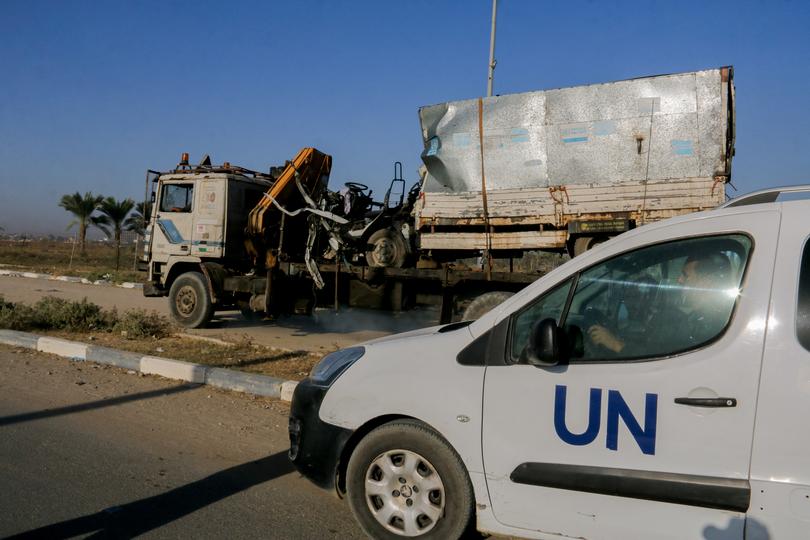 A United Nations (UN) vehicle near a destroyed van, with UN Relief and Works Agency (UNRWA) markings, following an Israeli strike on Salah al-Din Street south of Deir al-Balah, central Gaza in October. 