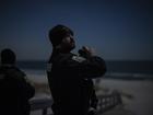 An Ocean County sheriff’ds officer scans the night sky for drones at Island Beach State Park, in Lanoka Harbor, New Jersey. 