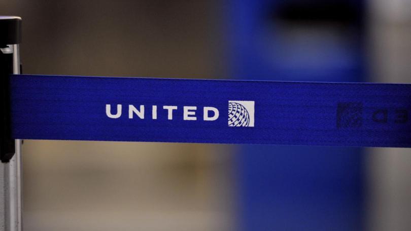 A body was found in the wheel well of a United plane's landing gear, after it arrived in Maui. (AP PHOTO)