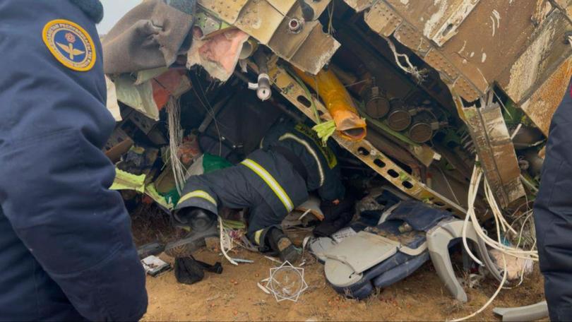 epa11792902 A handout photo made available by the press service of the Ministry for Emergency Situations of Kazakhstan shows emergency specialists working at the crash site of a passenger plane near Aktau, Kazakhstan, 25 December 2024. Azerbaijan Airlines Embraer ERJ-190AR passenger plane flying from Baku to Grozny crashed some three kilometres away from the city of Aktau. According to preliminary information, the incident was caused by a collision between the aircraft and a flock of birds. EPA/KAZAKHSTAN EMERGENCIES MINISTRY HANDOUT -- BEST QUALITY AVAILABLE -- MANDATORY CREDIT -- HANDOUT EDITORIAL USE ONLY/NO SALES Picture: KAZAKHSTAN EMERGENCIES MINISTRY HANDOUT